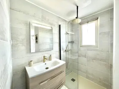 a white bathroom with a sink and a mirror at Vezelay 3 luxury 3 bedrooms, by Welcome to Cannes in Cannes