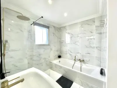 a white bathroom with a tub and a sink at Vezelay 3 luxury 3 bedrooms, by Welcome to Cannes in Cannes