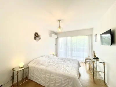 a white bedroom with a bed and a window at Vezelay 3 luxury 3 bedrooms, by Welcome to Cannes in Cannes