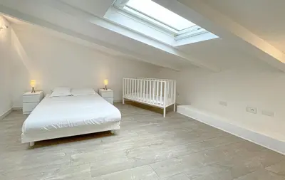 a white bedroom with a bed and a skylight at Tony Allard By Winsome Destination 4A in Cannes