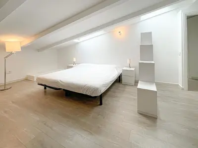 a white bedroom with a bed and two lamps at Tony Allard By Winsome Destination 4A in Cannes