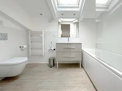 a white bathroom with a toilet and a sink at Tony Allard By Winsome Destination 4A in Cannes