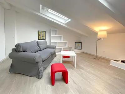 a living room with a couch and a red stool at Tony Allard By Winsome Destination 4A in Cannes