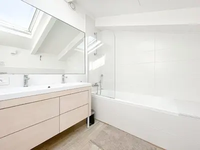 a white bedroom with a bed and a table at Tony Allard By Winsome Destination 4C in Cannes