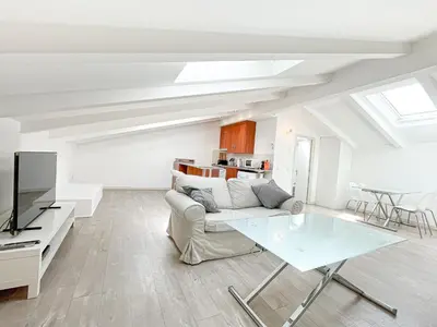 a living room with a white couch and a table at Tony Allard By Winsome Destination 4C in Cannes