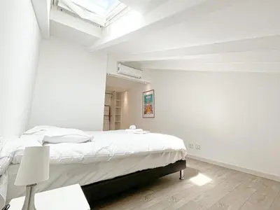 a white dining room with a table and chairs at Tony Allard By Winsome Destination 4C in Cannes