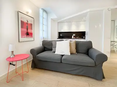a living room with a gray couch and a red table at Tony Allard By Winsome Destination 3F in Cannes