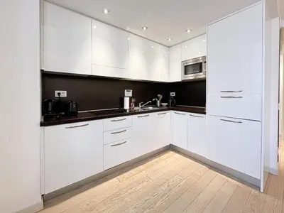 a white kitchen with white cabinets and a sink at Tony Allard By Winsome Destination 3F in Cannes