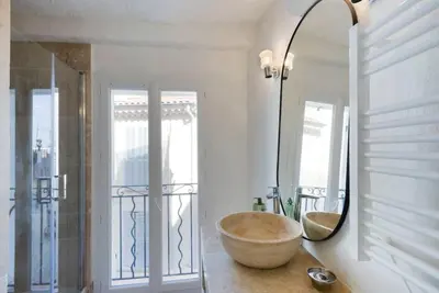 a bathroom with a bowl sink and a mirror at Le Suquet - Charming apartment in Cannes