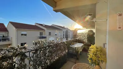 a view of a balcony of a building with the sun shining at Comfortable and modern two bedroom in Cannes