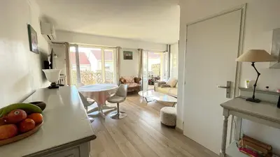 a kitchen and living room with a table and a living room at Comfortable and modern two bedroom in Cannes