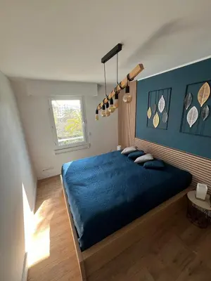 a bedroom with a blue bed and a window at Appartement T3 Cannes centre in Cannes