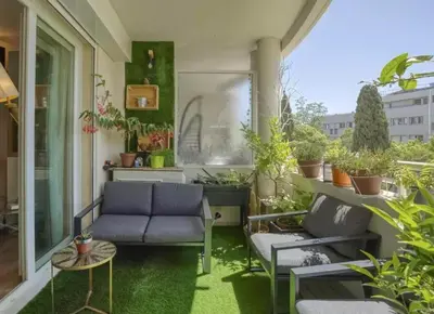 a balcony with chairs and a table and plants at Appartement T3 Cannes centre in Cannes