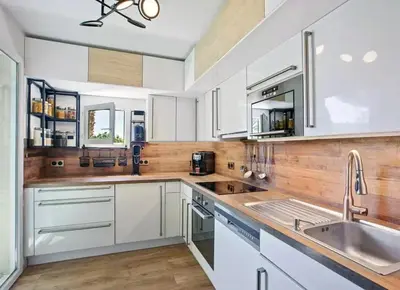 a kitchen with white cabinets and a sink at Appartement T3 Cannes centre in Cannes