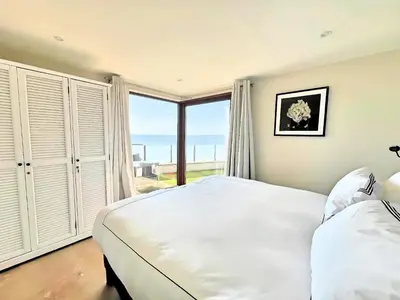 a bedroom with a large bed and a large window at Villa Marsa - Cannes - on beach in Cannes