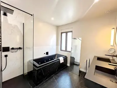 a bathroom with a tub and a glass shower at Villa Marsa - Cannes - on beach in Cannes