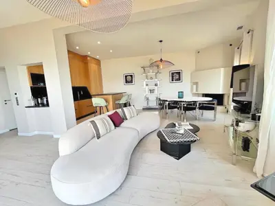 a living room with a white couch and a table at Villa Marsa - Cannes - on beach in Cannes