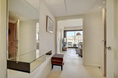 a hallway with a glass desk and a chair at Carlton Riviera Cannes - Dernier étage - Palme d'Or in Cannes
