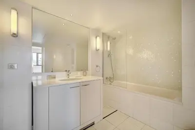 a white bathroom with a sink and a tub at Carlton Riviera Cannes - Dernier étage - Palme d'Or in Cannes