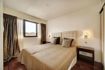 a bedroom with a large bed and a window at Carlton Riviera Cannes - Dernier étage - Palme d'Or in Cannes