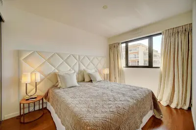 a bedroom with a large bed and a window at Carlton Riviera Cannes - Dernier étage - Palme d'Or in Cannes