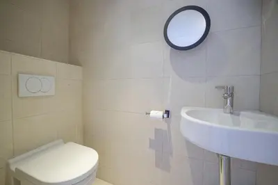 a bathroom with a sink and a toilet and a mirror at Carlton Riviera Cannes - Dernier étage - Palme d'Or in Cannes