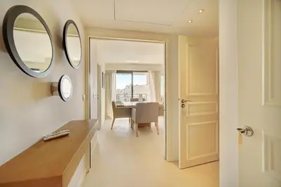 a bathroom with a mirror and a dining room at Carlton Riviera Cannes - Dernier étage - Palme d'Or in Cannes