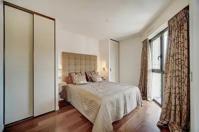 a bedroom with a bed and a large window at Carlton Riviera Cannes - Dernier étage - Palme d'Or in Cannes