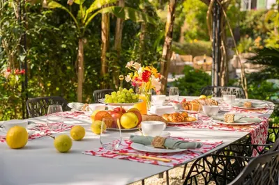 a white table with food and fruit on it at Cannes centre maison bourgeoise in Cannes