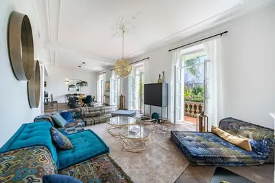 a living room with blue couches and a tv at Cannes centre maison bourgeoise in Cannes
