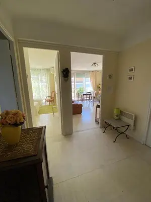 a living room with a couch and a table at 3 Pièces avec grande terrasse in Cannes