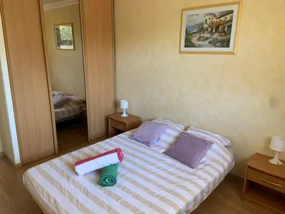 a bedroom with a bed and a large mirror at T2 à proximité des plages in Cannes
