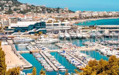 a group of boats docked in a harbor at APRT Cannes Beach Festival ARNESE in Cannes