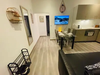 a living room and kitchen with a table and a couch at APRT Cannes Beach Festival ARNESE in Cannes