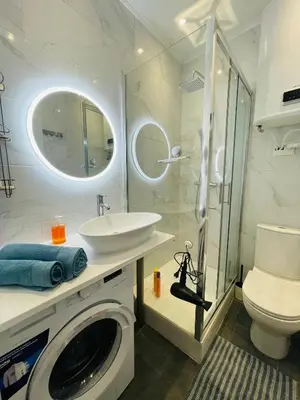 a bathroom with a sink and a washing machine at APRT Cannes Beach Festival ARNESE in Cannes