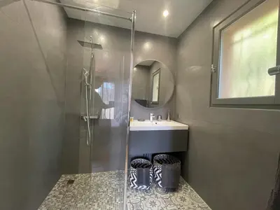 a bathroom with a shower and a sink and a mirror at Carolienne in Vallauris