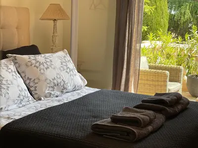 a bed with two towels on top of it at Carolienne in Vallauris