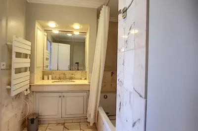 a bathroom with a sink and a mirror at 2 bdr apartment with garden next to the Croisette in Cannes
