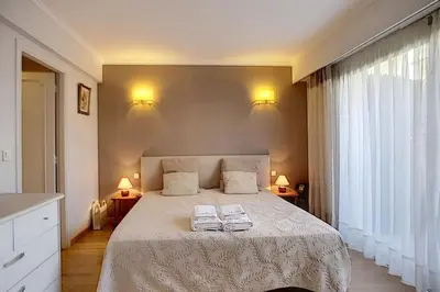 a bedroom with a bed with two towels on it at 2 bdr apartment with garden next to the Croisette in Cannes