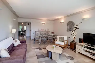 a living room with a couch and a table at 2 bdr apartment with garden next to the Croisette in Cannes