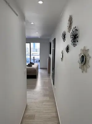 a hallway with a living room with a heart on the wall at Superbe Studio avec balcon Rue d’Antibes in Cannes