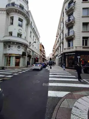 a street with a crosswalk in a city with buildings at Superbe Studio avec balcon Rue d’Antibes in Cannes