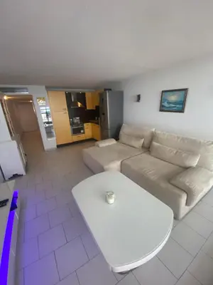 a living room with a couch and a table at Appartement Front de mer à Cannes -Vue Mer & Terrasse in Cannes