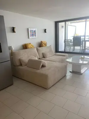 a living room with a couch and a table at Appartement Front de mer à Cannes -Vue Mer & Terrasse in Cannes