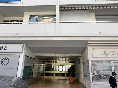 a man walking in front of a building at Colony 2 in Cannes