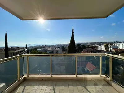 a balcony with a view of a city at A013-Apt vue mer avec piscine et terrasse in Cannes