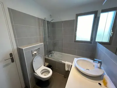 a bathroom with a toilet and a sink at A013-Apt vue mer avec piscine et terrasse in Cannes