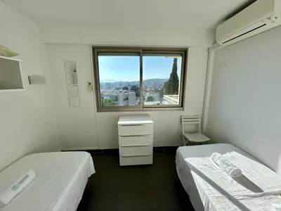 a hospital room with two beds and a window at A013-Apt vue mer avec piscine et terrasse in Cannes