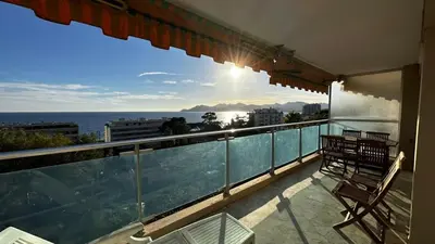 a balcony with two chairs and a view of the ocean at A069-Apt in residence with pool and sea view - Cannes in Cannes