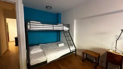 a bedroom with a bunk bed with a blue wall at A069-Apt in residence with pool and sea view - Cannes in Cannes